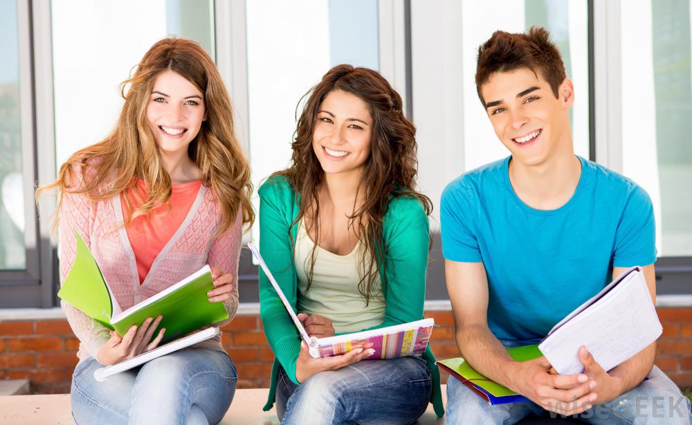 2474_two-girls-and-one-boy-student-smiling-with-notebooks.jpg